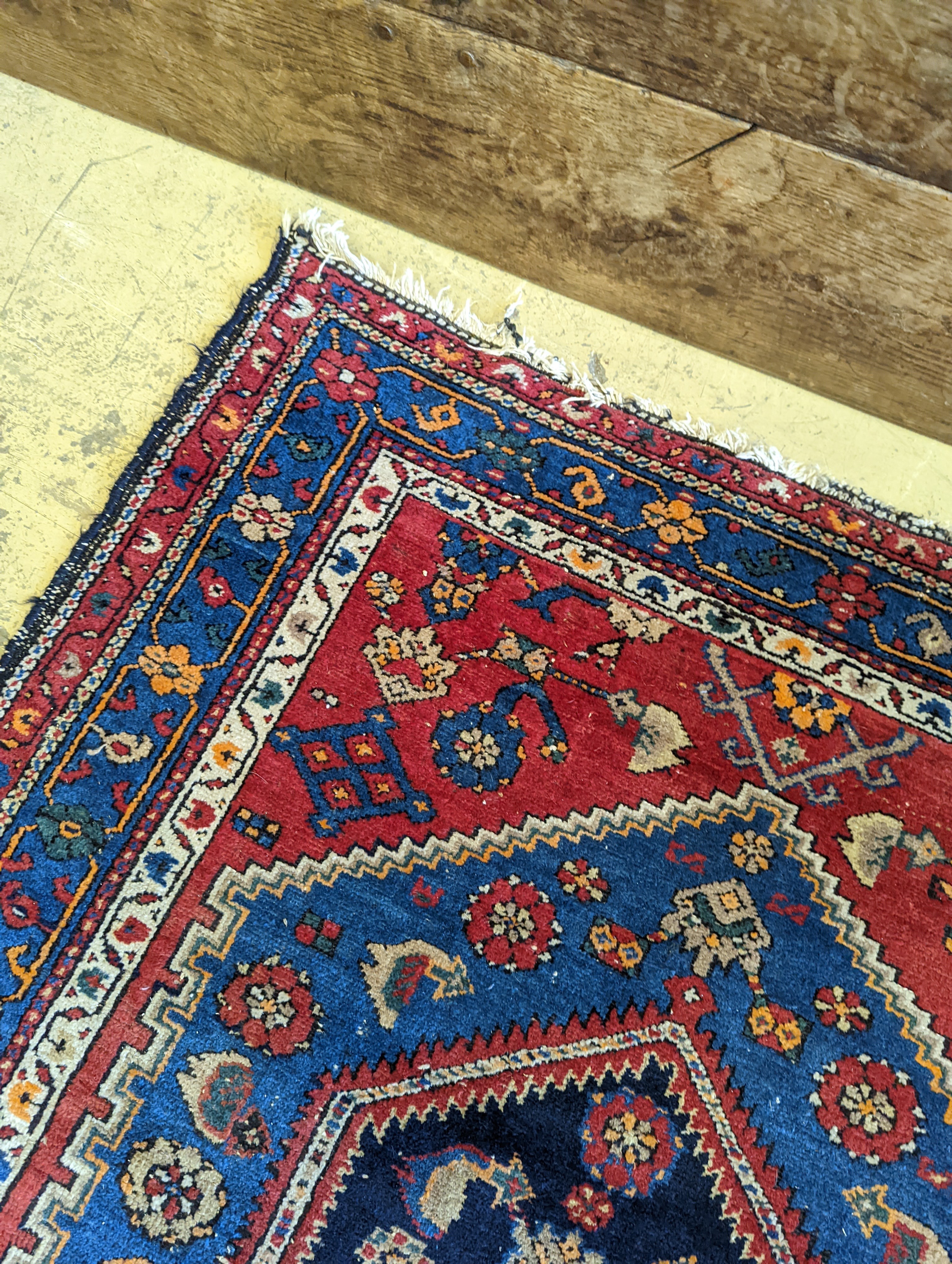 A Caucasian brick red ground rug, 194 x 130cm